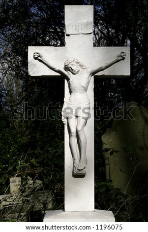 Marble statue of Jesus on cross at old Graveyard