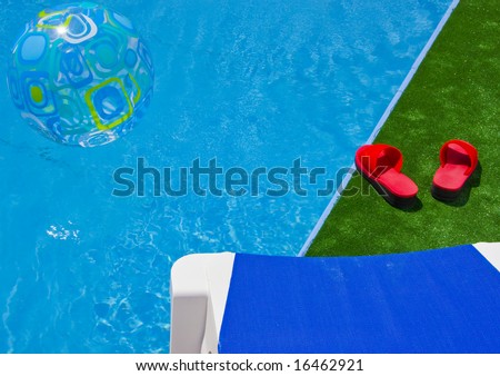 Swimming pool with sun lounger detail, red sandals and water ball
