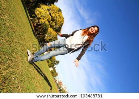 A young woman jumping in the Park.