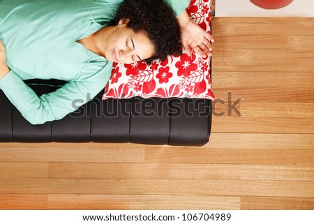 A jung brazilian woman sleeping on the sofa.