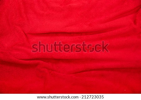 A wavy red blanket background.