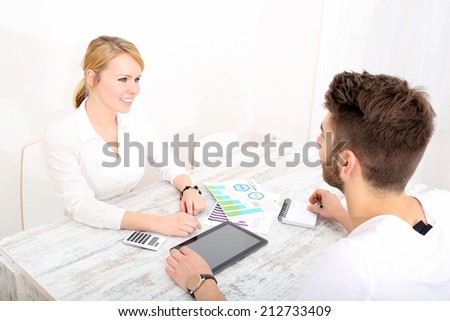 A happy young couple organizing their financial situation at home.