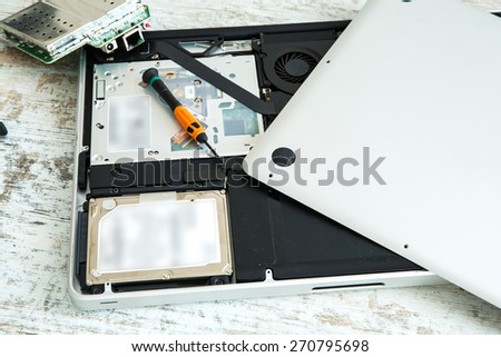 A open laptop getting repaired.