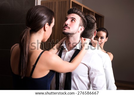 A young couple preparing to go out and getting ready and dressed in the changing room.