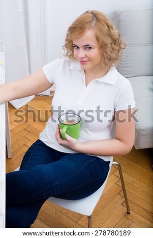 A plus size adult woman working in the home office.