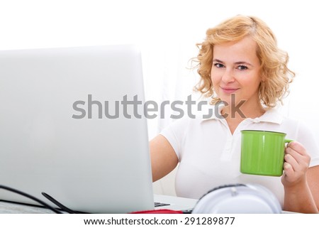 A plus size adult woman working in the home office.