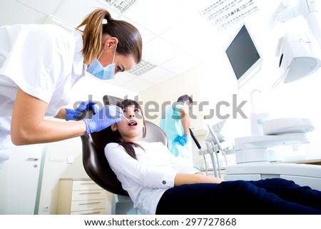 A young girl getting her dental checkup at the dentist.