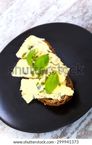 European style sandwiches with Roquefort cheese and Basil leaves on dark bread.