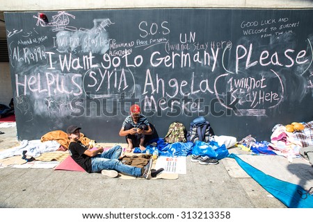 BUDAPEST, HUNGARY - SEPTEMBER 04: Syrian refugees demand help from Germany written on a wall at the Train Station Keleti Palyudvar on September 04, 2015 in Budapest, Hungary.