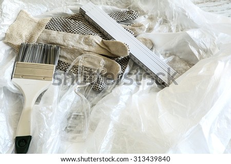Painting Tools for home renovation with some plastic foil for covering.