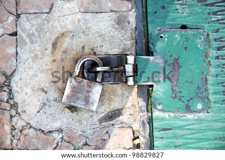 A rusty metal plate background with a padlock.