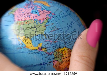 the world / globe in  woman\'s hand.  Can illustrate many concepts such as business, politics or worldwide issues from woman\'s perspective.  Selective focus on globe.