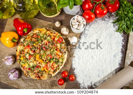 Freshly baked pizza and copy space for the menu on the flour