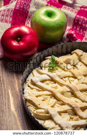 Apples and apple cake with icing sugar and mint leaf