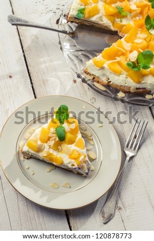 Piece of peaches cake served with cream