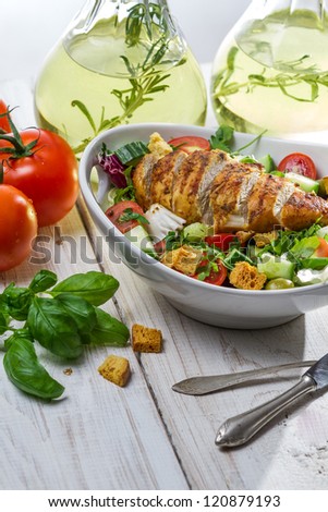 Healthy salad with chicken and olive oil