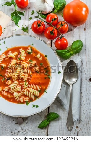 Plate of tomato soup with fresh vegetables handmade