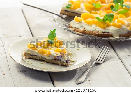 Closeup of cake with cream and peaches