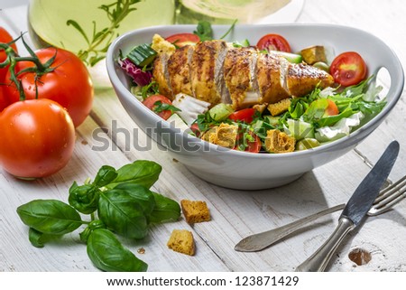 Closeup of healthy salad with chicken and ingredients
