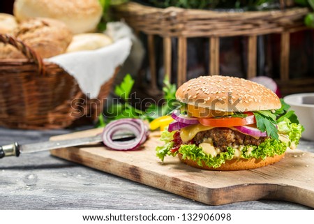 Closeup of burger made Ã?Â¢??Ã?Â¢??from beaf and fresh vegetables