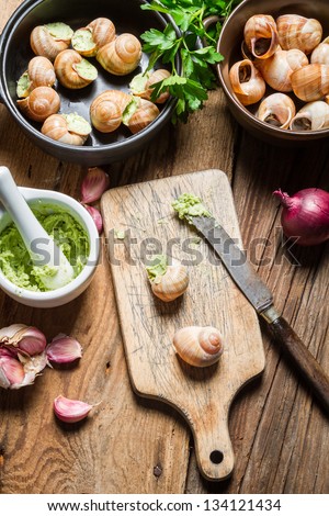 Preparing snails with garlic butter and herbs