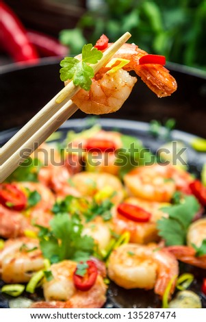 Tasting fried shrimp with fresh herbs