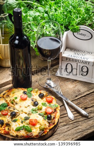 Freshly pizza served with red wine