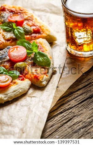 Baked pizza served with a cold drink with copy space place