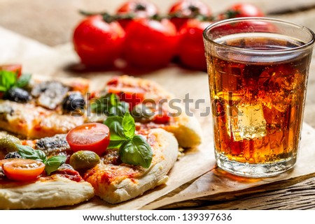 Freshly baked pizza and served with cold drink