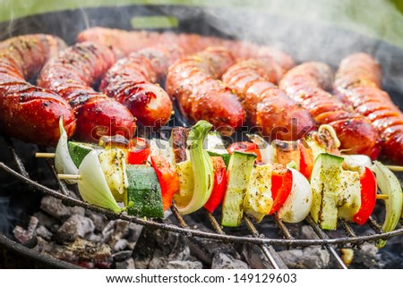 Sausages and skewers on the grill