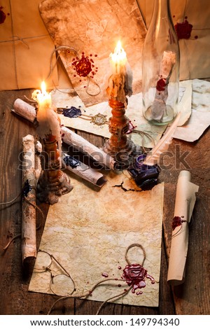 Old scrolls and candles are the old scribe\'s workplace