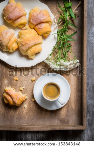 Breakfast in bed with a croissant and flowers