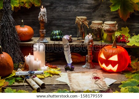 Table in witch hut with halloween pumpkin