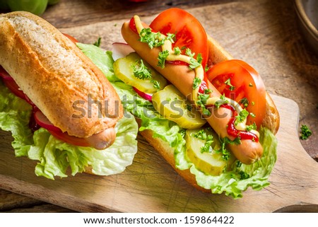 Two fresh homemade hot dog with mustard and ketchup