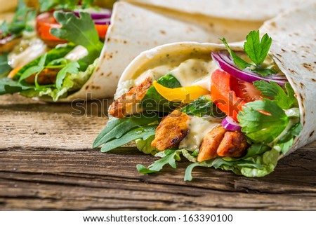 Closeup of tasty kebab with vegetables and chicken