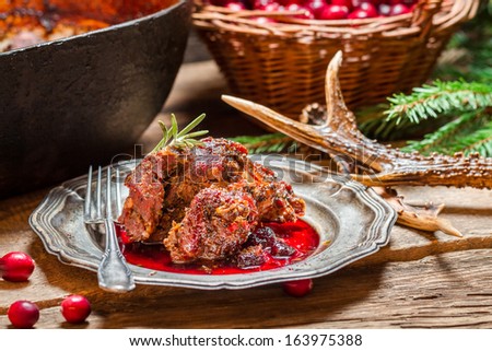 Venison with cranberry sauce in the forester