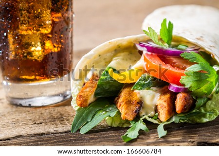 Closeup of kebab with fresh vegetables and chicken on black background