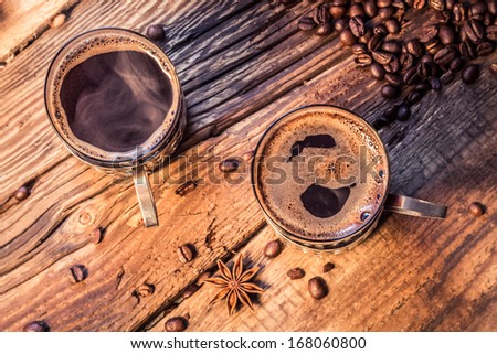 Closeup of hot coffee in old wooden table