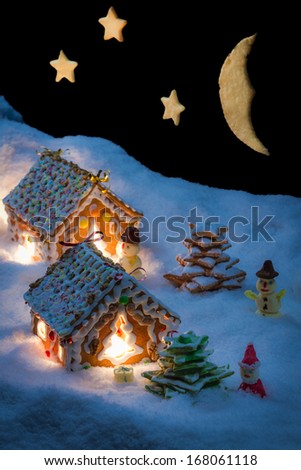 Snowy gingerbread cottage with stars and moon