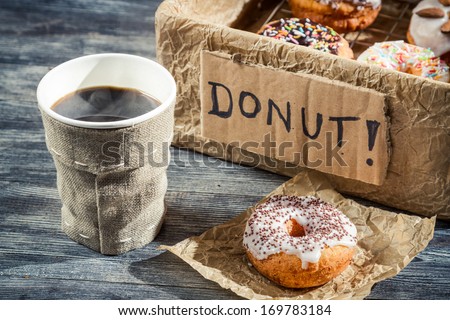 Closeup of hot coffee and box with donuts