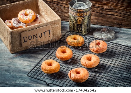 Preparing to decorate donuts with icing sugar