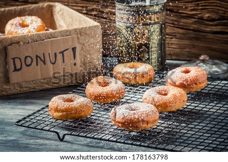 Preparing to decorate donuts with powder sugar