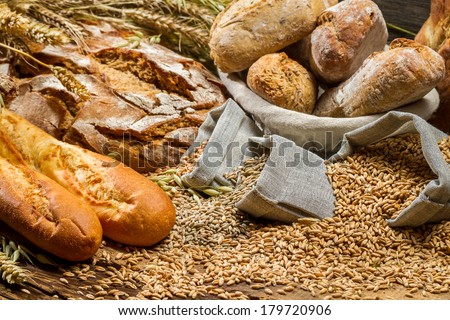 Various kinds of whole wheat bread on old wooden table