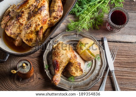 Roasted chicken and jacket potato served with wine