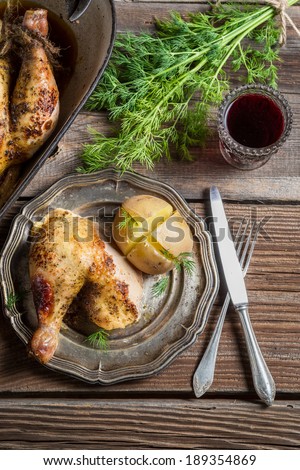 Jacket potato and roasted chicken served with wine