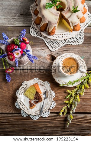 Cup of coffee, easter cake and spring flowers