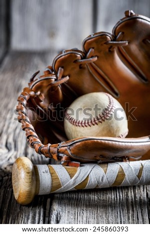 Old baseball bat and glove with ball