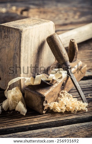Wooden hammer, planer and chisel on a carpentry workbench