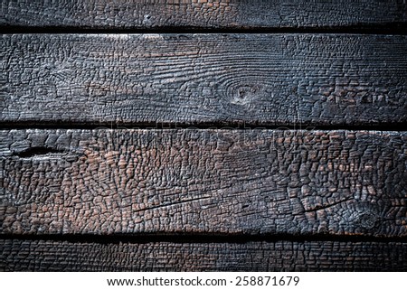 Closeup of burnt wooden fence
