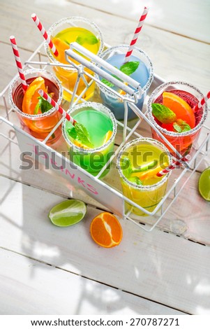 Sweet lemonade with straw and fruits